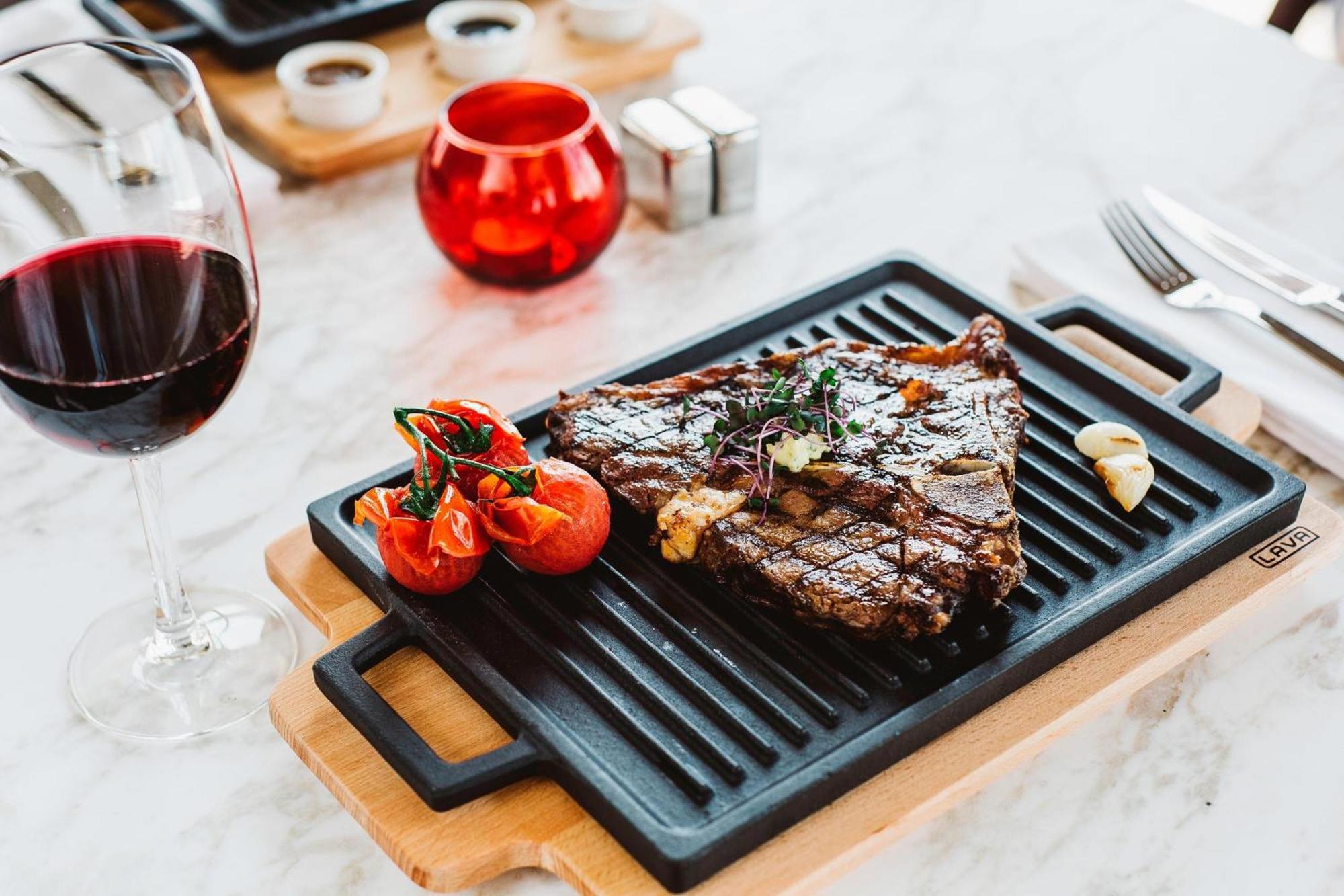 Sheraton Batumi Hotel Exterior photo A steak served on a griddle